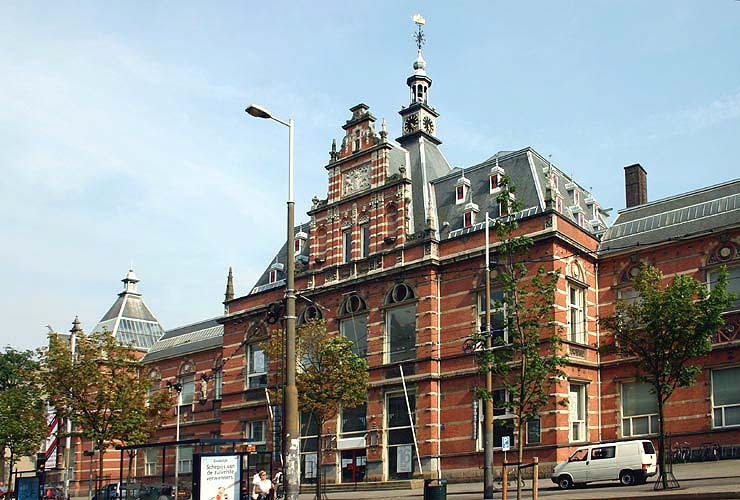 Red-brick building with ornate architecture and a tower, identified as the Stedelijk Museum Amsterdam