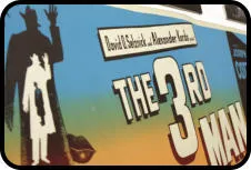 Een bord met de titel 'THE 3RD MAN' in grote witte letters, een silhouet van een man met hoed en koffer, en tekst met 'David R. C. Williams, Alexander Korda'.