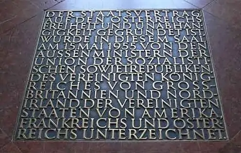 bronze plaque with engraved german text on a stone floor