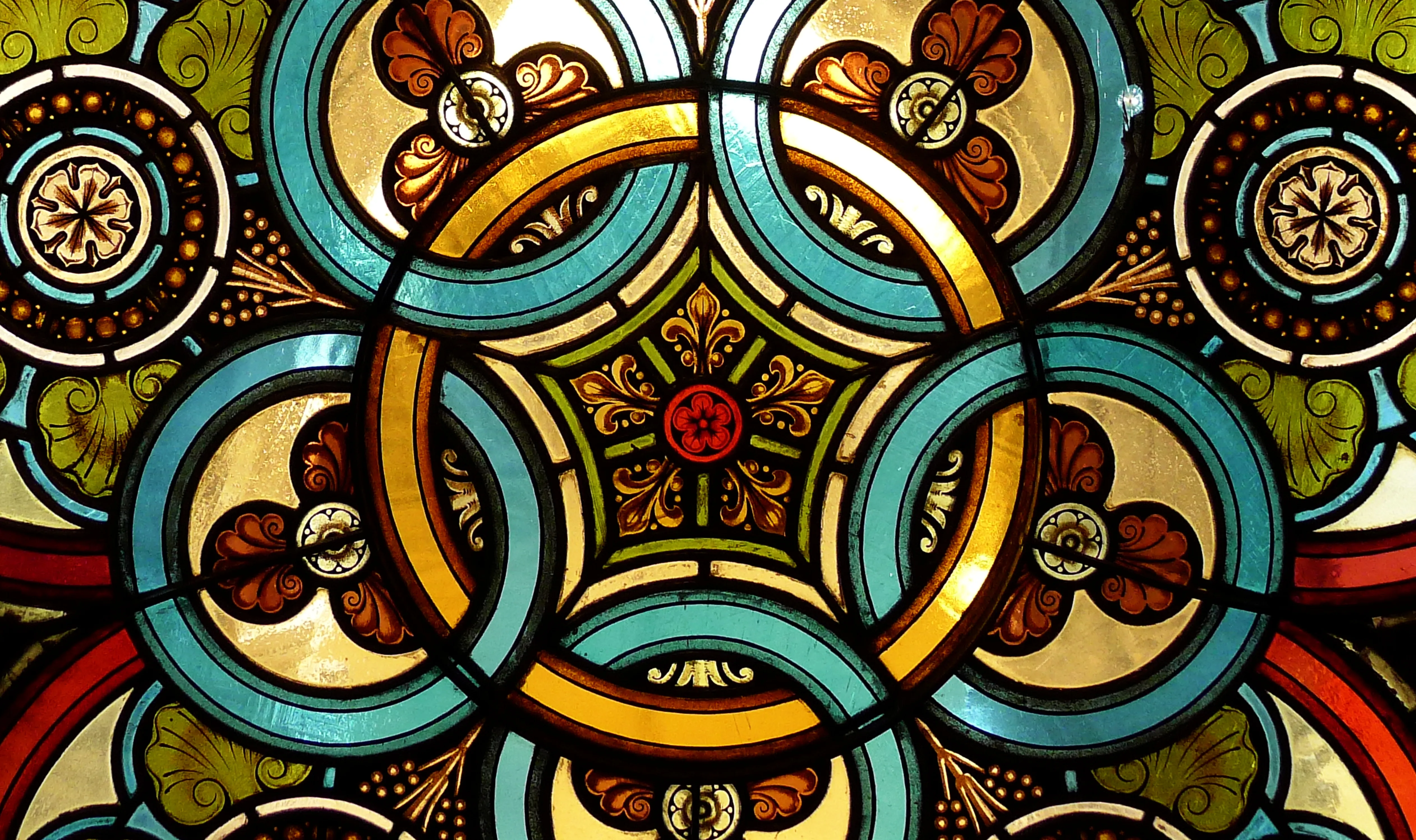 close-up of stained glass window with intricate geometric patterns and vibrant colors