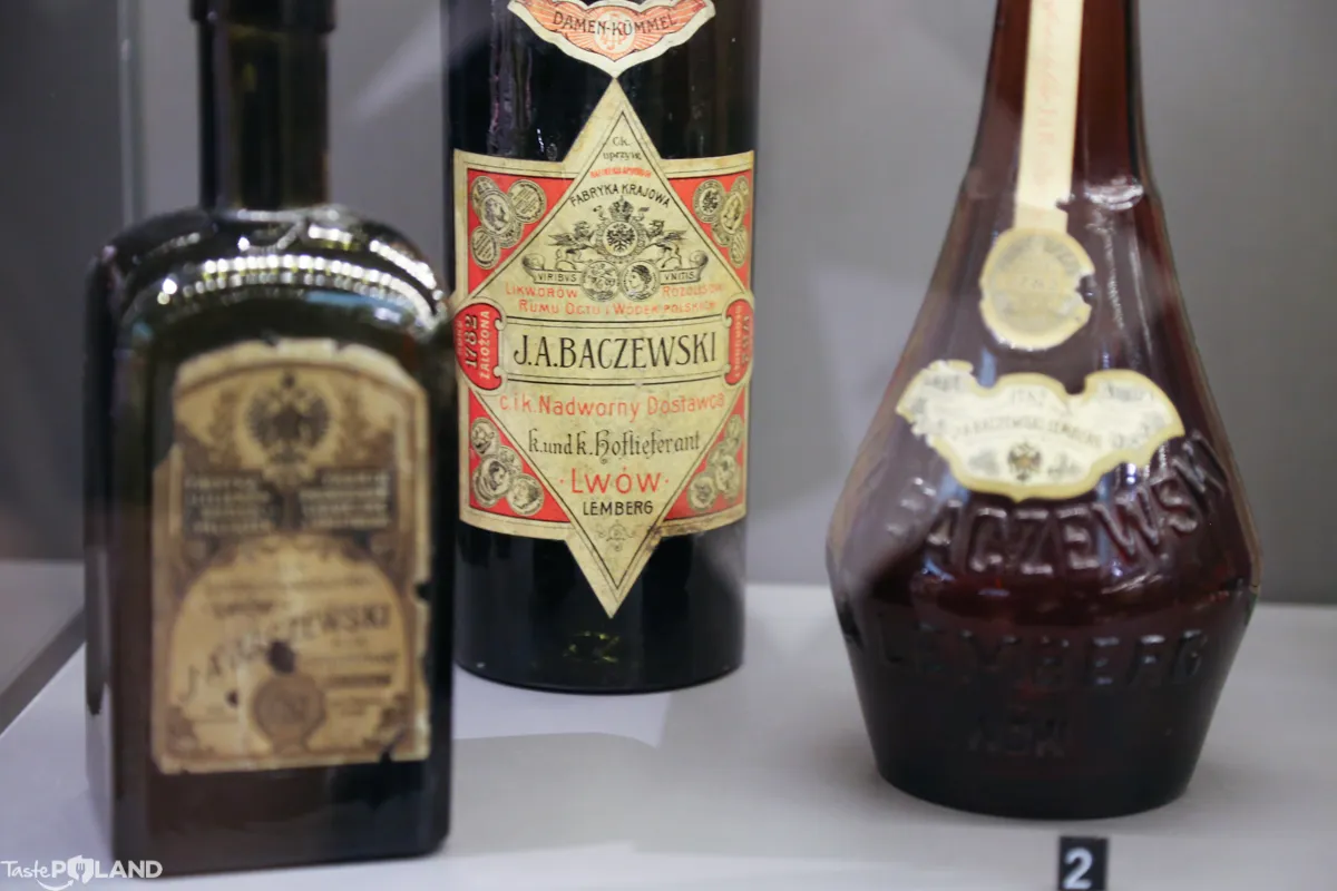 Three vintage vodka bottles with ornate labels on display