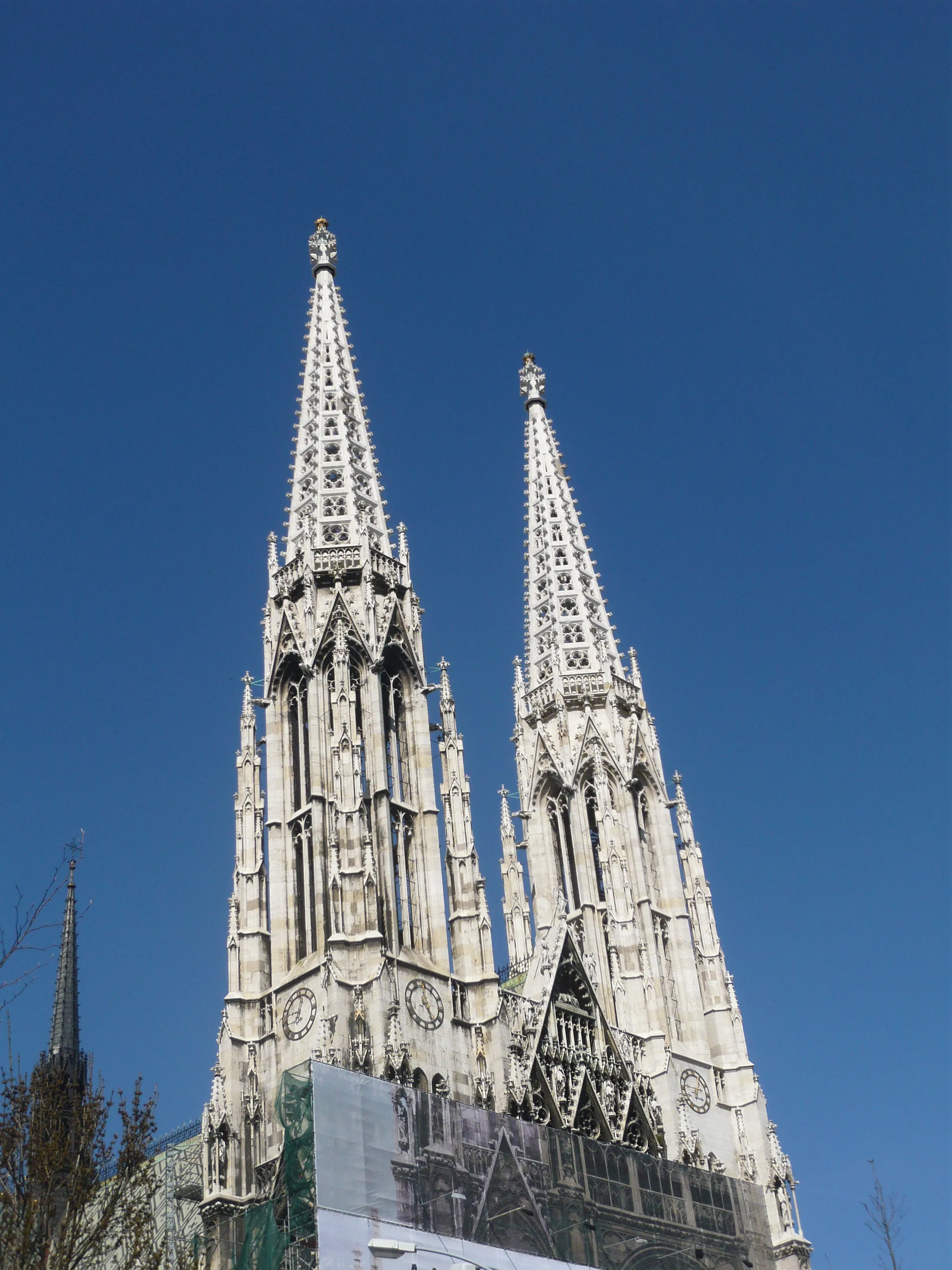 Twin spires of the Votive Church against a clear blue sky