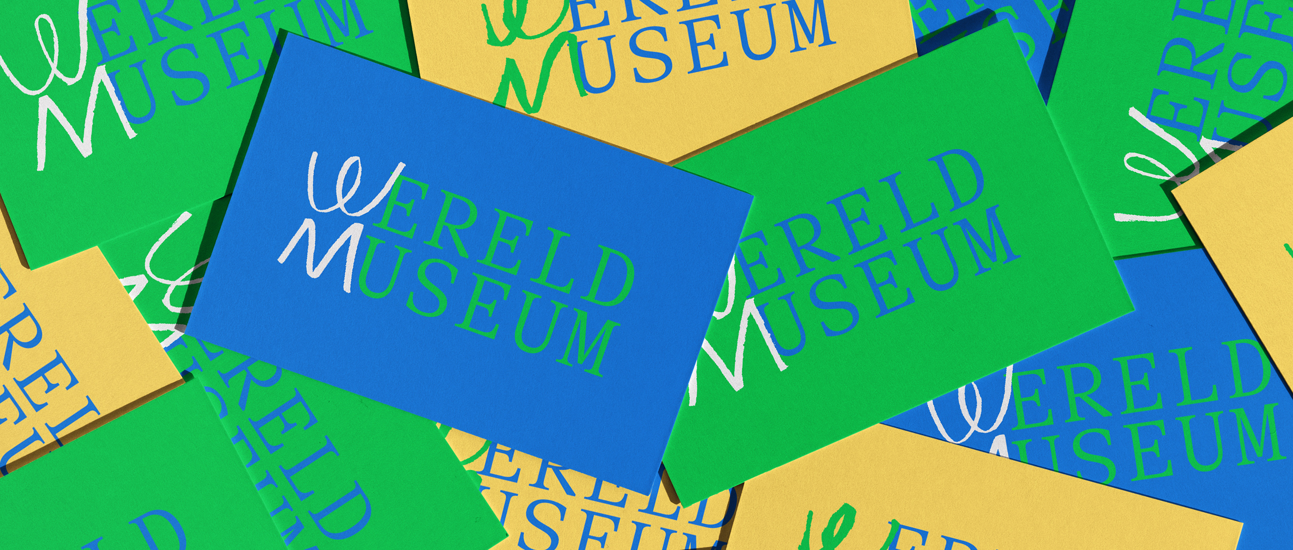 Colorful blue, green, and yellow cards displaying 'WERELD MUSEUM' text in white and green lettering