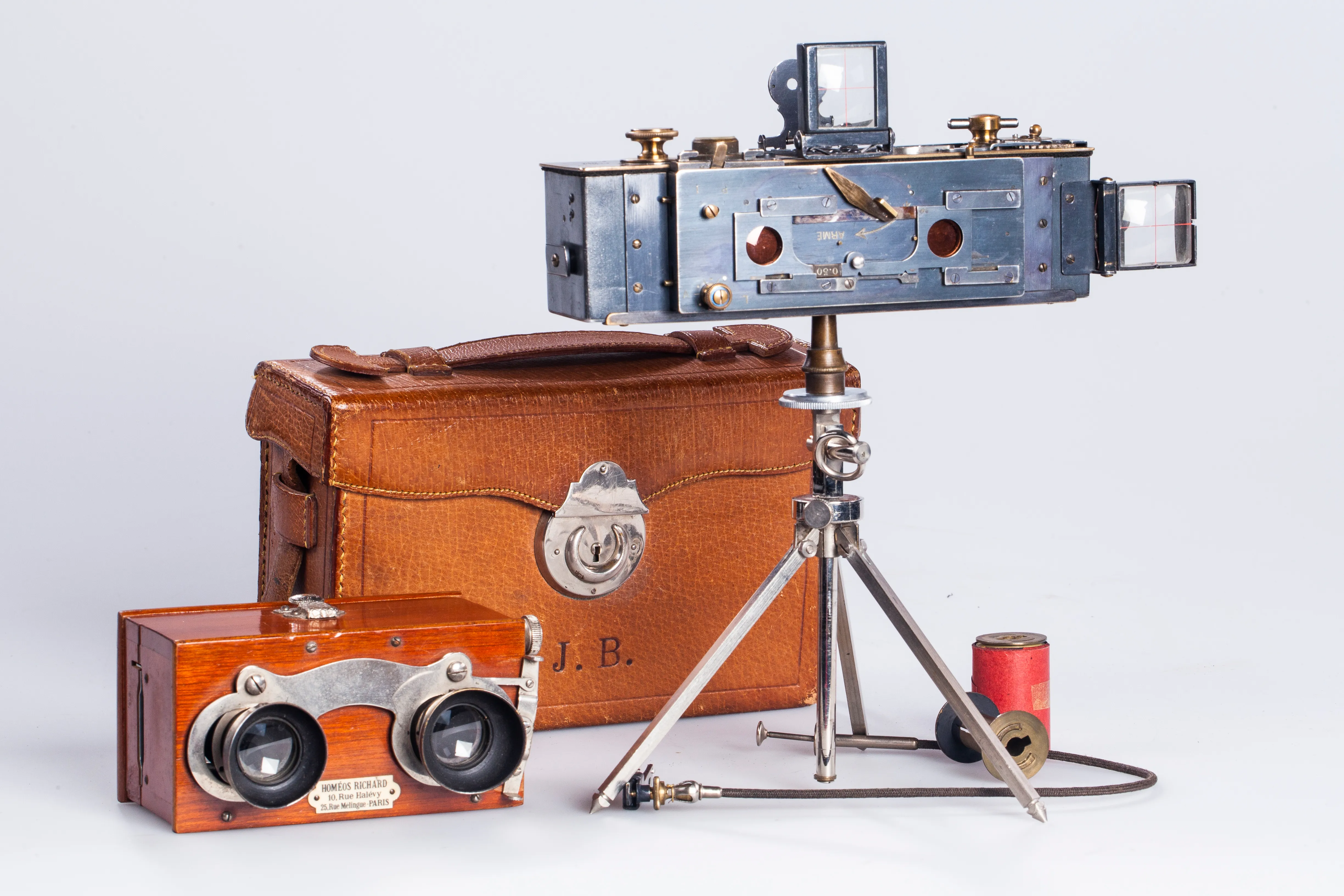 vintage camera on tripod, stereoscopic viewer, and leather case